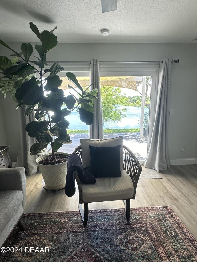 1021 Alabama Ave, Holly Hill, FL 32117 - sitting room with wood finished floors, a textured ceiling, and baseboards
