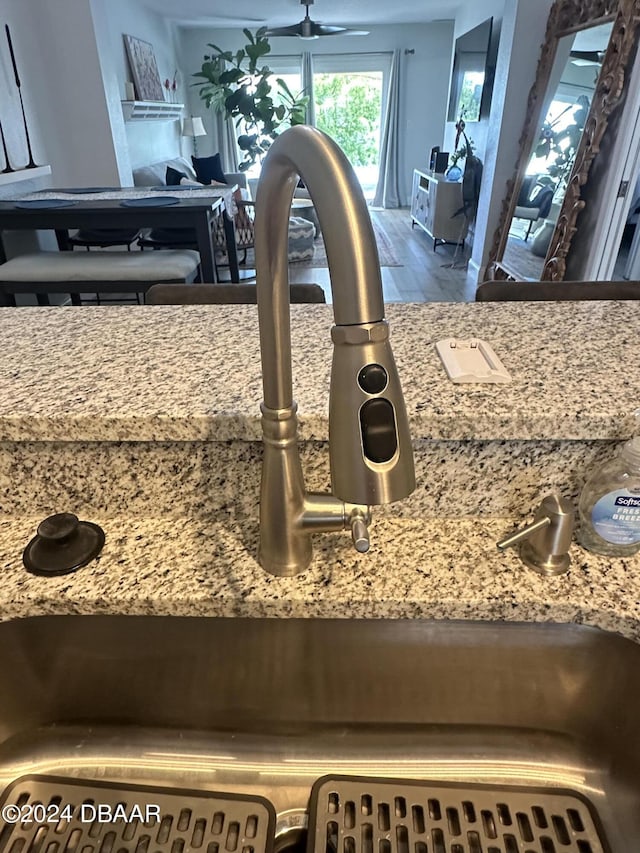 1021 Alabama Ave, Holly Hill, FL 32117 - kitchen view of a sink, wood finished floors, and light stone counters