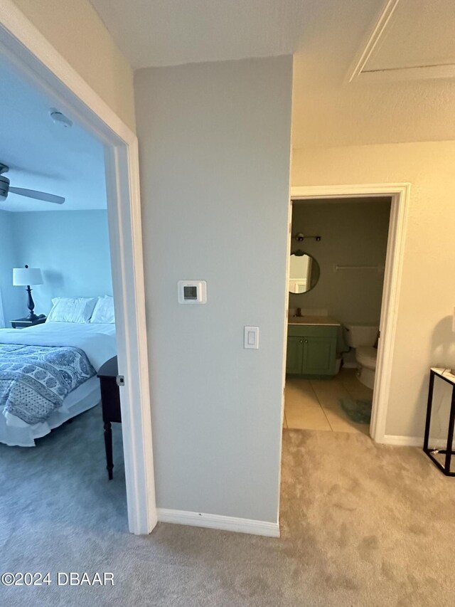1021 Alabama Ave, Holly Hill, FL 32117 - bedroom featuring carpet floors, ensuite bathroom, and baseboards
