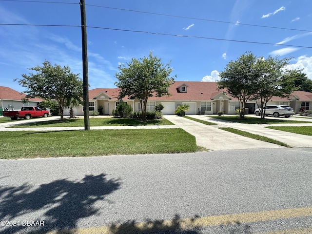 1021 Alabama Ave, Holly Hill, FL 32117 - single story home with driveway, a garage, and a front lawn