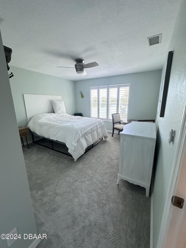 1021 Alabama Ave, Holly Hill, FL 32117 - bedroom featuring carpet, a ceiling fan, and a textured ceiling