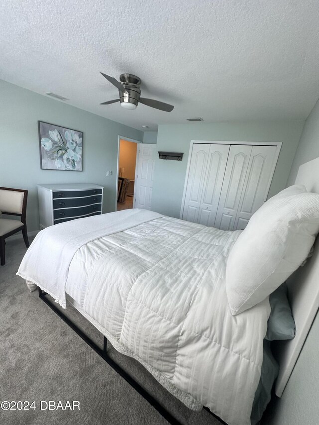 1021 Alabama Ave, Holly Hill, FL 32117 - bedroom with a closet, carpet, a textured ceiling, and a ceiling fan