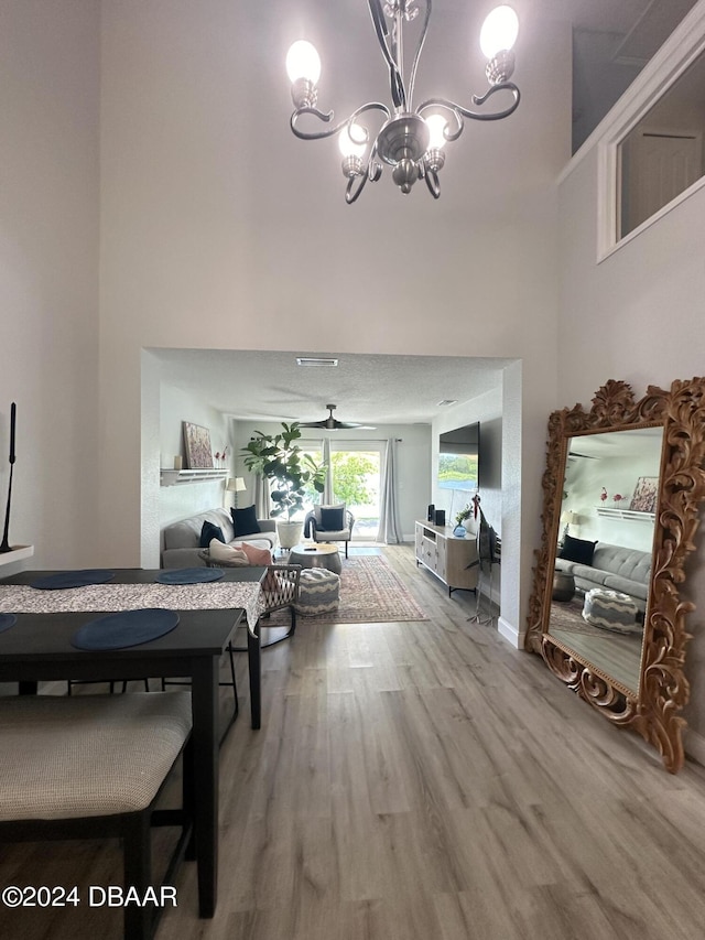 1021 Alabama Ave, Holly Hill, FL 32117 - living area featuring wood finished floors, a chandelier, and a towering ceiling