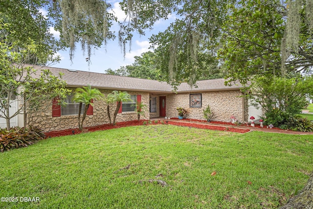 1409 Mollie Rd, Daytona Beach, FL 32114 - single story home featuring stone siding, a front lawn, and roof with shingles