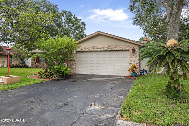 1409 Mollie Rd, Daytona Beach, FL 32114 - view of front of property featuring stone siding, concrete driveway, a front lawn, and a garage