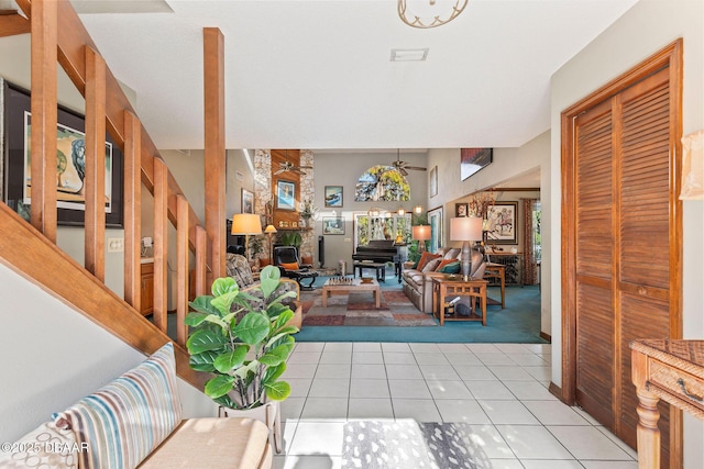 tiled living room featuring ceiling fan