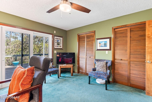 office space with ceiling fan, light colored carpet, and a textured ceiling