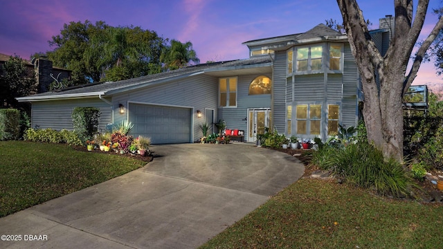 view of front of house with a lawn and a garage