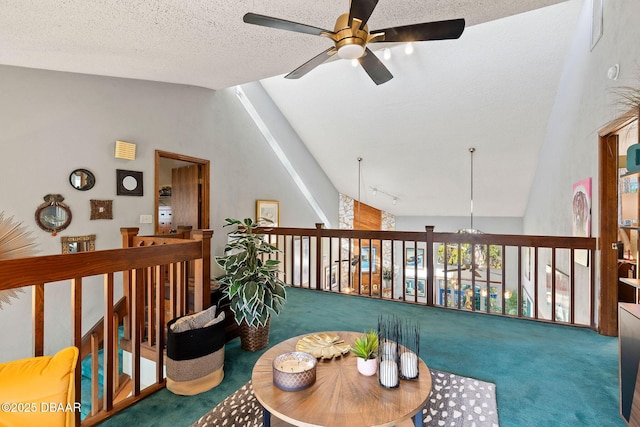 living area featuring carpet flooring, a textured ceiling, vaulted ceiling, and ceiling fan