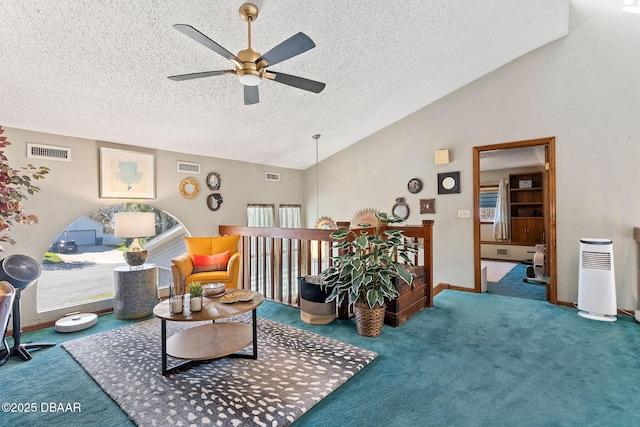 carpeted living room featuring a textured ceiling, ceiling fan, and lofted ceiling