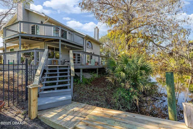 back of property featuring a wooden deck