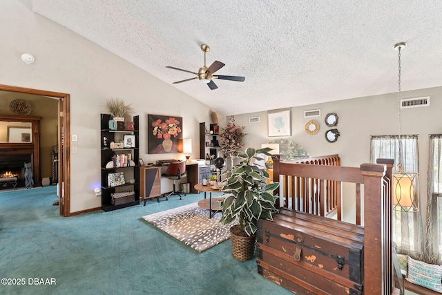 living area with lofted ceiling, ceiling fan, carpet floors, and a textured ceiling