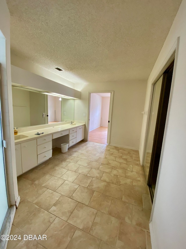 bathroom featuring vanity and a textured ceiling