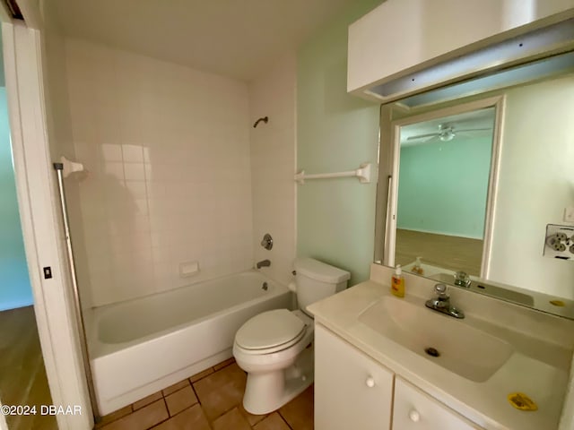 full bathroom with tile patterned floors, vanity, tiled shower / bath combo, toilet, and ceiling fan