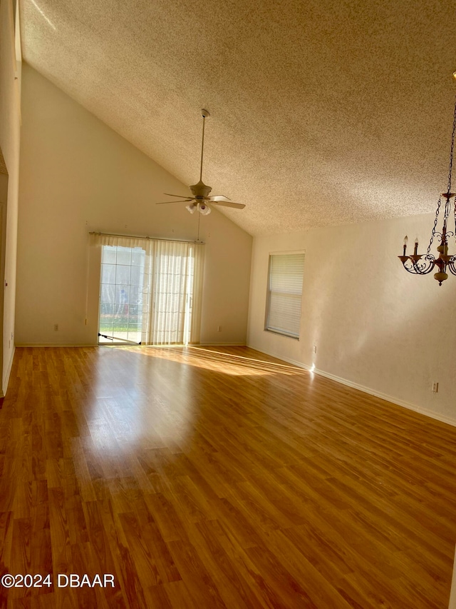 unfurnished room with hardwood / wood-style floors, lofted ceiling, a textured ceiling, and ceiling fan