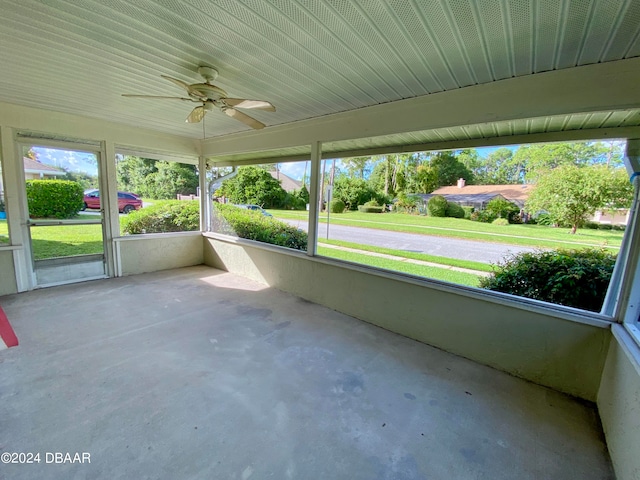 unfurnished sunroom featuring ceiling fan