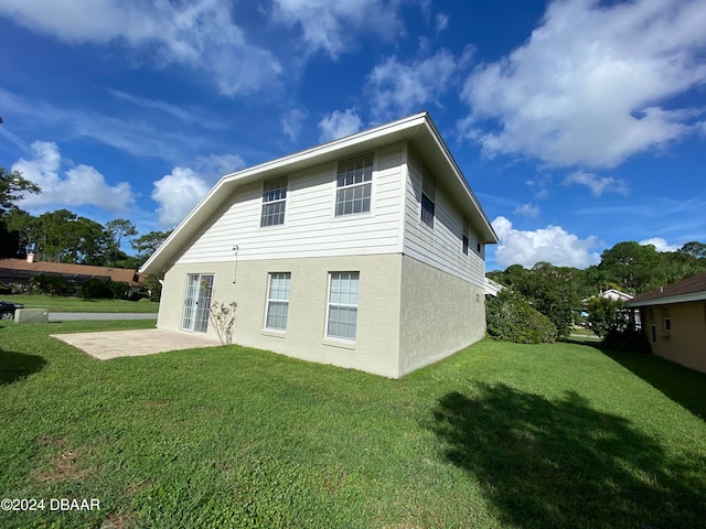 back of property with a patio and a yard