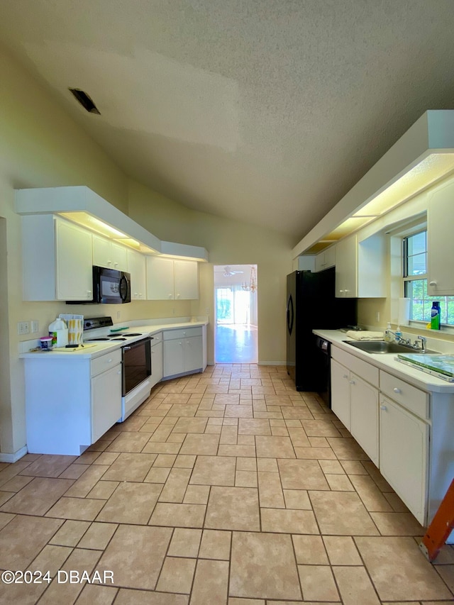 kitchen featuring black appliances, white cabinetry, a textured ceiling, sink, and vaulted ceiling