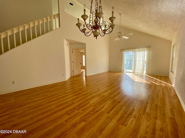 unfurnished living room featuring hardwood / wood-style floors, ceiling fan with notable chandelier, a textured ceiling, and high vaulted ceiling