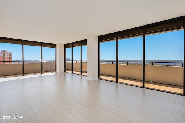 unfurnished room with a water view and plenty of natural light