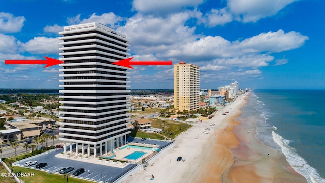 aerial view with a water view and a view of the beach