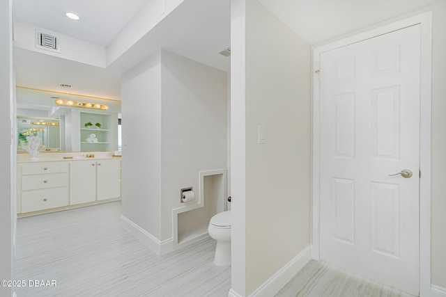 bathroom with toilet and vanity