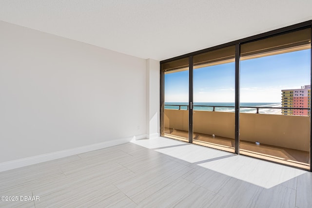 spare room featuring a water view