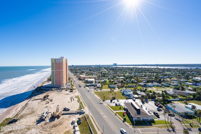 bird's eye view featuring a water view and a beach view