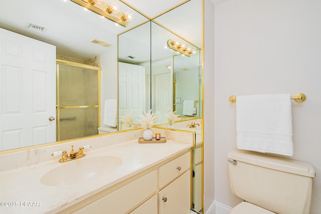 bathroom with toilet, a shower with shower door, and vanity