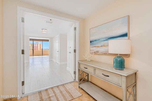 hallway featuring light tile patterned floors