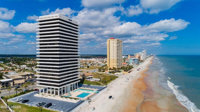 drone / aerial view with a water view and a beach view