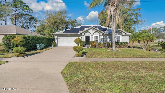 ranch-style house with a front lawn, solar panels, and a garage