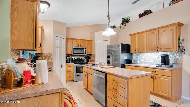 kitchen with light tile patterned floors, a center island with sink, stainless steel appliances, decorative backsplash, and pendant lighting