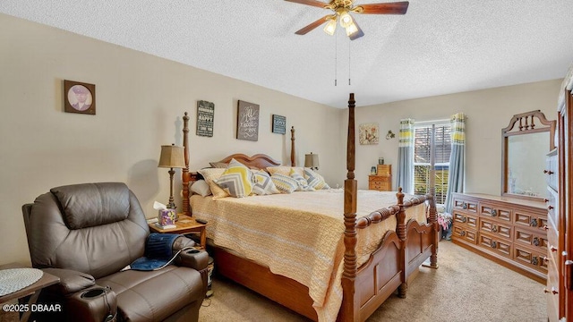 bedroom with ceiling fan, light colored carpet, and a textured ceiling