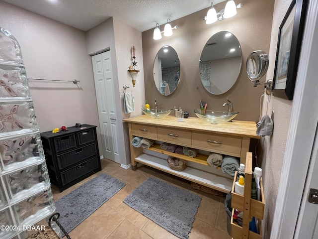 bathroom featuring vanity, a textured ceiling, and tile patterned floors