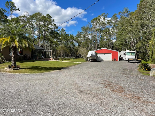 view of home's exterior with a garage, an outbuilding, and a lawn