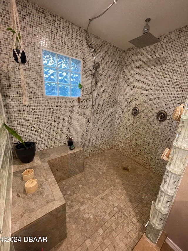 bathroom with tile walls and a tile shower