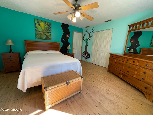 bedroom with ceiling fan, a closet, and light wood-type flooring