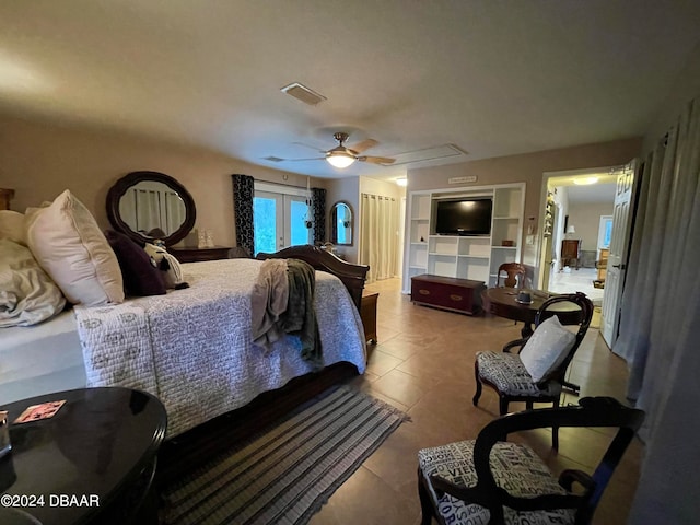 tiled bedroom featuring ceiling fan