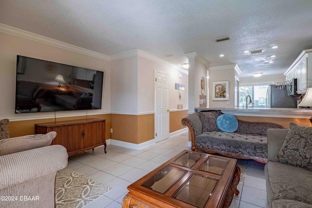 tiled living room with ornamental molding, a textured ceiling, and sink