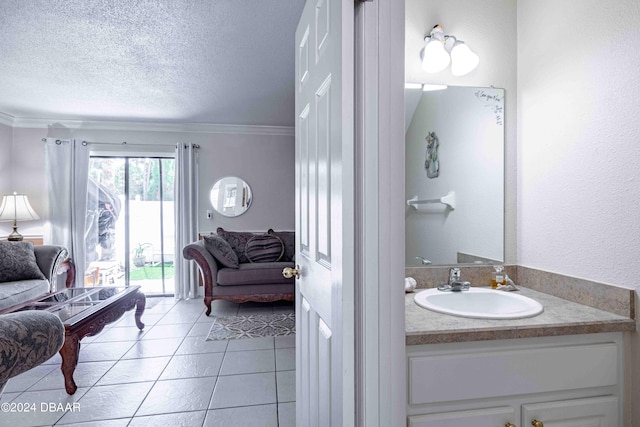 bathroom featuring vanity, a textured ceiling, tile patterned floors, and ornamental molding