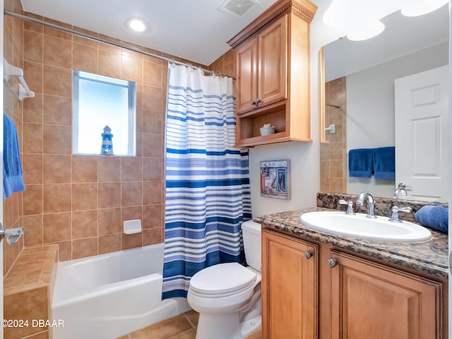 full bathroom with tile patterned floors, vanity, toilet, and shower / bath combo with shower curtain