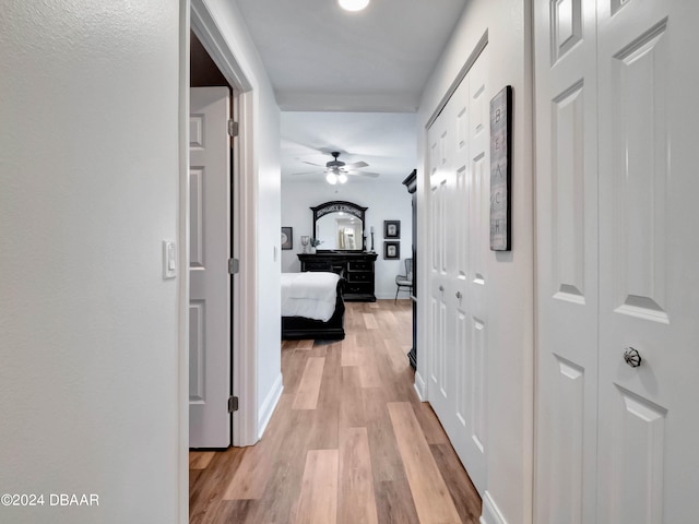 corridor with light hardwood / wood-style flooring