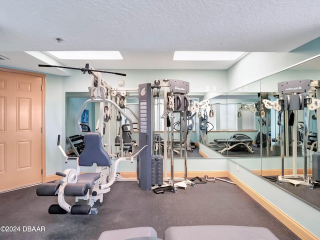 701 N Atlantic Ave Unit 202, New Smyrna Beach, FL 32169 - gym featuring a textured ceiling and baseboards