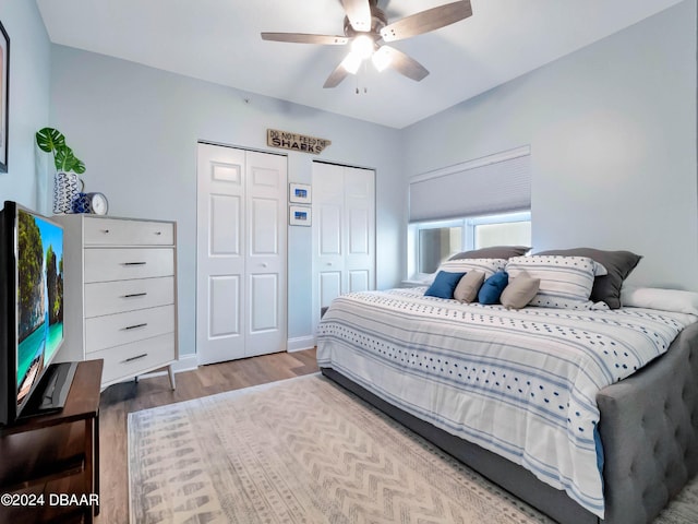 701 N Atlantic Ave Unit 202, New Smyrna Beach, FL 32169 - bedroom featuring multiple closets, wood finished floors, and a ceiling fan