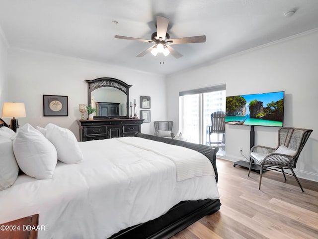 bedroom featuring ceiling fan, light hardwood / wood-style floors, and ornamental molding