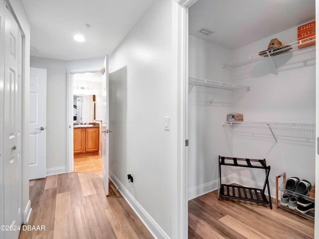 701 N Atlantic Ave Unit 202, New Smyrna Beach, FL 32169 - laundry area with light wood-type flooring and baseboards