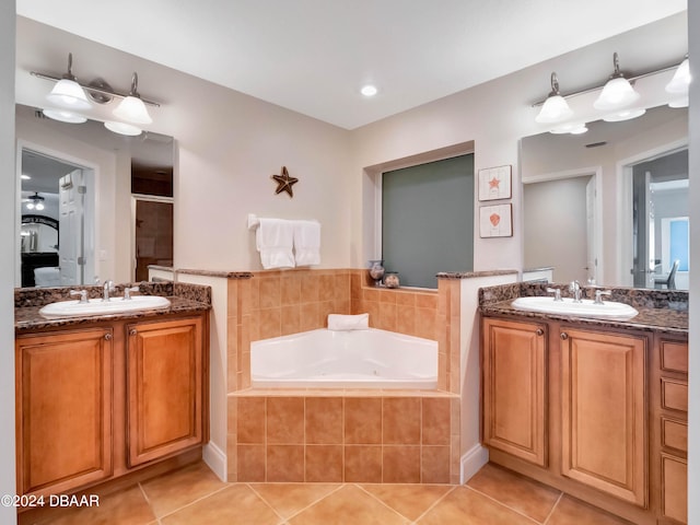 bathroom featuring tile patterned flooring, vanity, and plus walk in shower