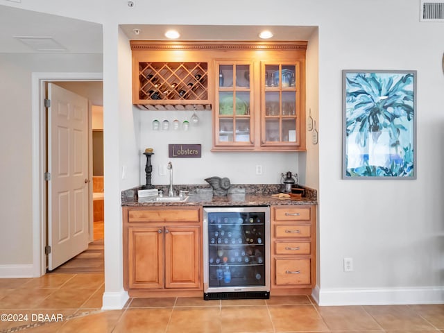 701 N Atlantic Ave Unit 202, New Smyrna Beach, FL 32169 - indoor wet bar with beverage cooler, baseboards, light tile patterned flooring, and recessed lighting