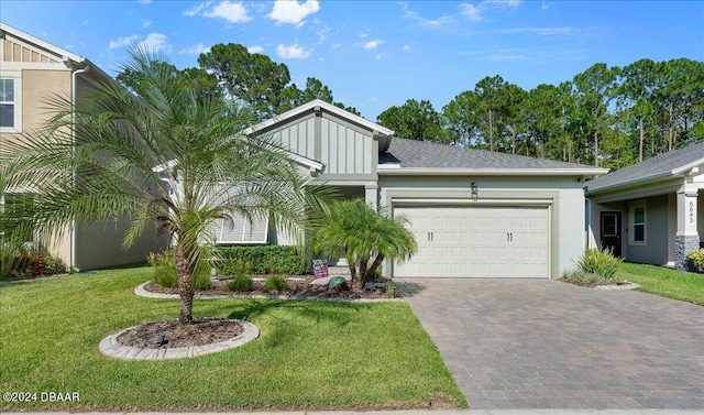 view of front of property featuring a garage and a front yard